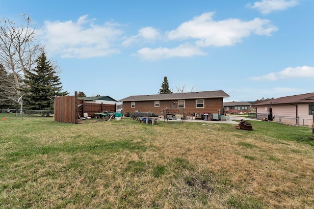 rear view of house featuring a yard