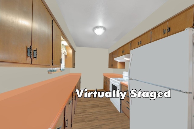 kitchen with light wood-type flooring, stove, and white refrigerator