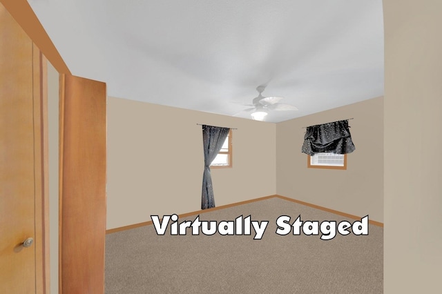 carpeted spare room with ceiling fan