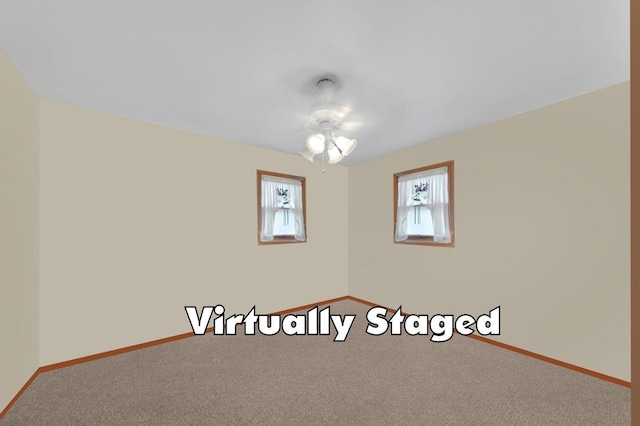 carpeted spare room with ceiling fan