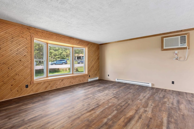 spare room featuring a wall mounted AC, dark hardwood / wood-style floors, baseboard heating, and wood walls