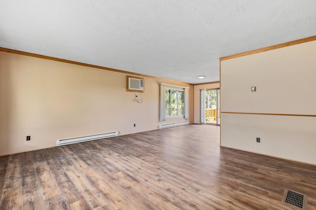 unfurnished room featuring a wall mounted air conditioner, wood-type flooring, a baseboard radiator, and ornamental molding