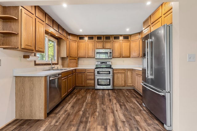 kitchen featuring appliances with stainless steel finishes, dark wood-type flooring, and sink