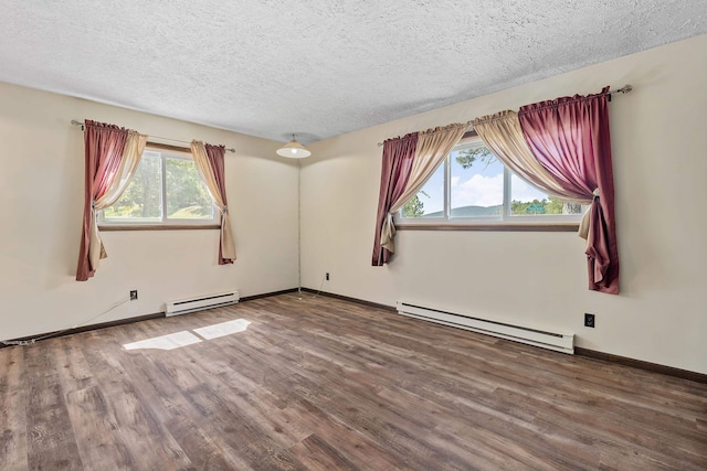 unfurnished room featuring baseboard heating, a textured ceiling, and hardwood / wood-style flooring