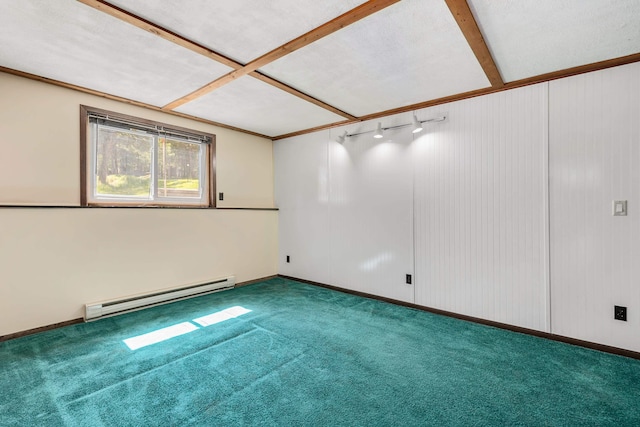 carpeted spare room featuring a baseboard heating unit