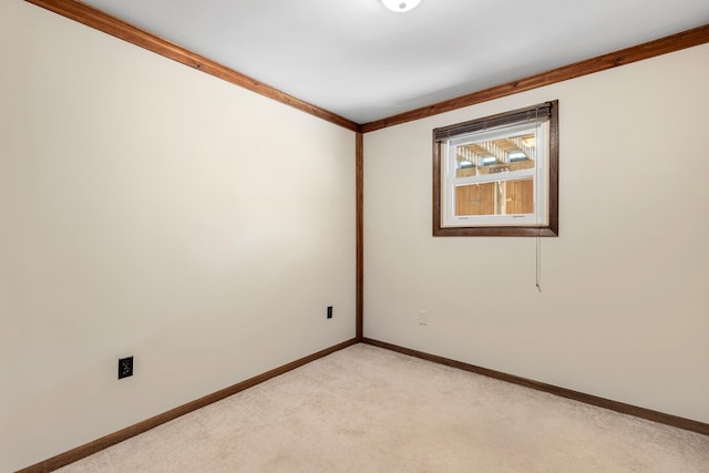 unfurnished room featuring light carpet and crown molding