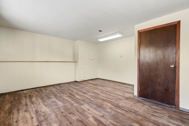 empty room with hardwood / wood-style flooring