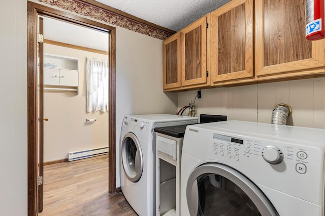 laundry area featuring cabinets, a baseboard radiator, separate washer and dryer, wood-type flooring, and a textured ceiling