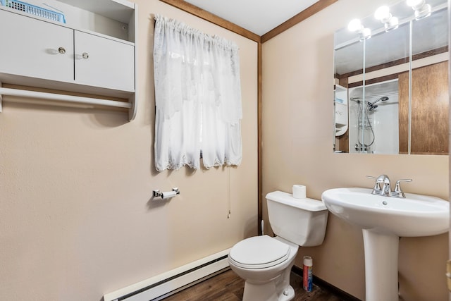 bathroom featuring ornamental molding, a baseboard heating unit, sink, hardwood / wood-style floors, and toilet