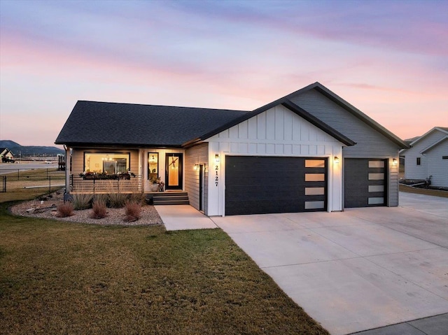 view of front facade with a yard and a garage