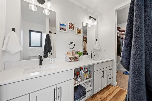 bathroom featuring vanity, hardwood / wood-style flooring, and toilet