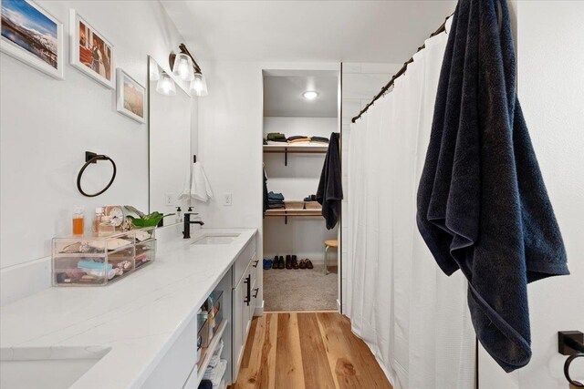 bathroom featuring hardwood / wood-style flooring and vanity