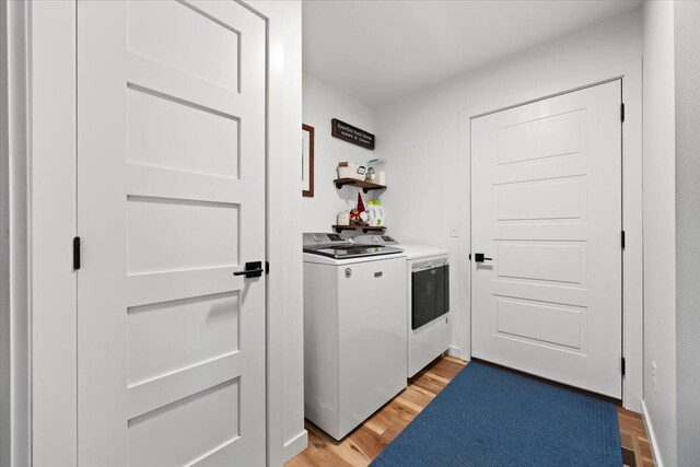 laundry room with light hardwood / wood-style floors and independent washer and dryer