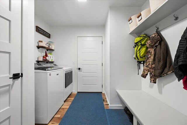 laundry room with wood-type flooring and independent washer and dryer