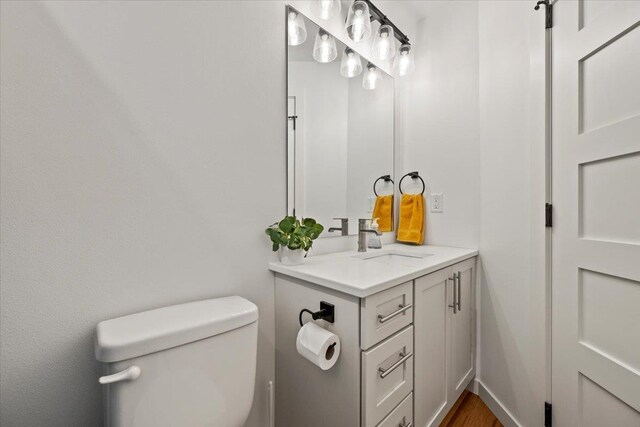 bathroom featuring vanity and toilet