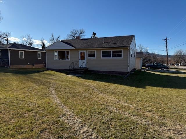 back of house with a lawn