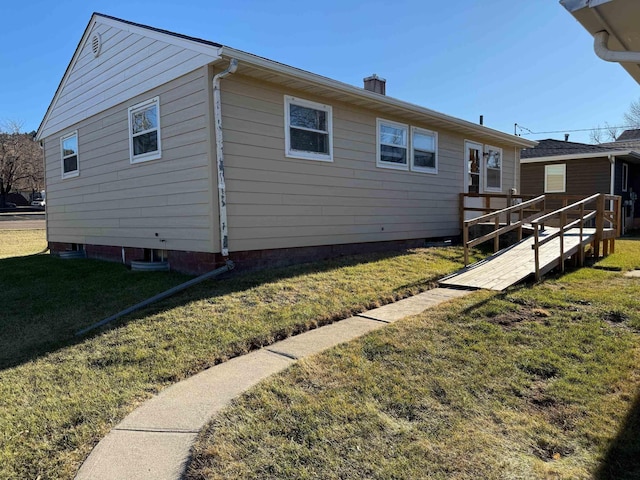 view of home's exterior featuring a lawn and a wooden deck