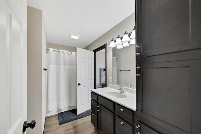 bathroom featuring shower / tub combo with curtain, vanity, and wood-type flooring