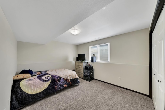 bedroom featuring carpet and a closet