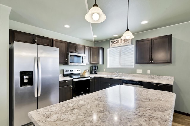 kitchen featuring sink, hanging light fixtures, stainless steel appliances, light hardwood / wood-style flooring, and dark brown cabinets