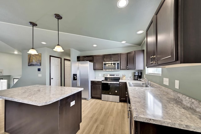 kitchen with pendant lighting, sink, light wood-type flooring, dark brown cabinetry, and stainless steel appliances