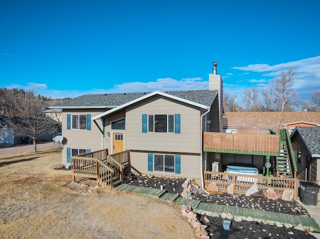 view of front of house featuring a deck and a jacuzzi