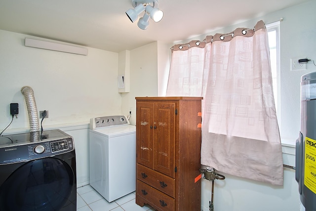 laundry area with light tile patterned flooring, cabinets, separate washer and dryer, and water heater