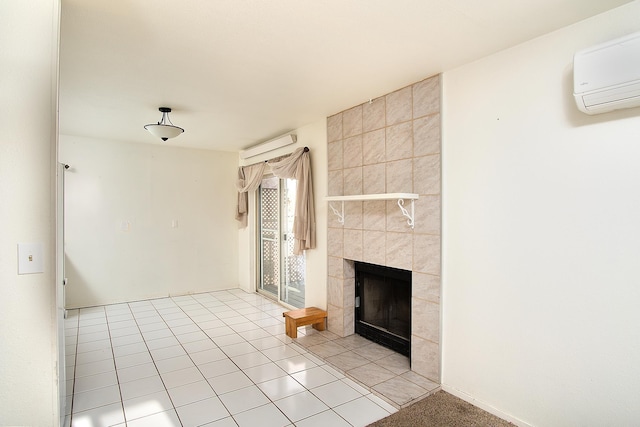 unfurnished living room featuring a tile fireplace, light tile patterned floors, and a wall unit AC