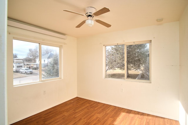 spare room featuring hardwood / wood-style floors and ceiling fan