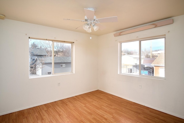 empty room with light hardwood / wood-style floors and ceiling fan