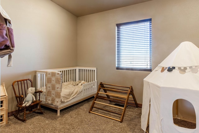 bedroom featuring carpet and a nursery area