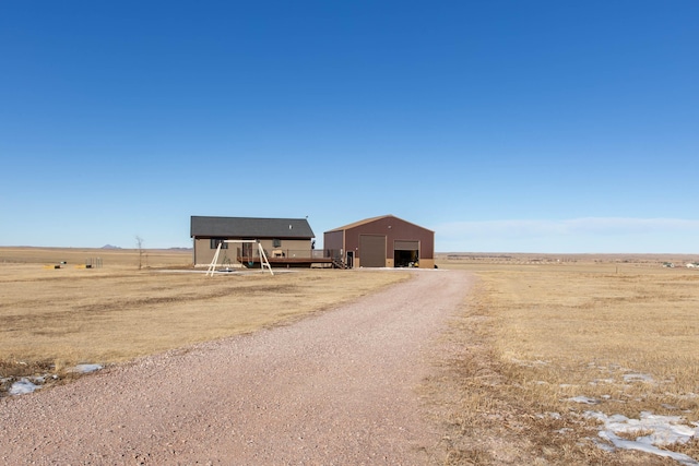 exterior space with a rural view and a garage