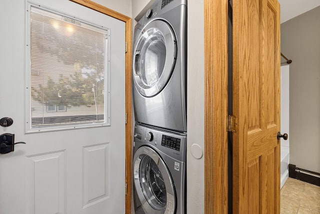 washroom with light tile patterned floors and stacked washer / dryer