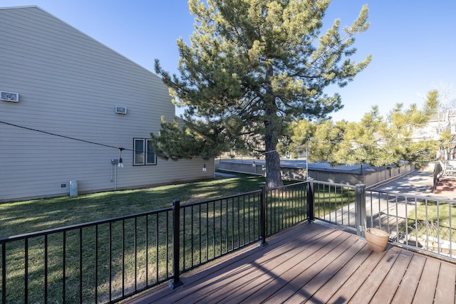 wooden terrace featuring a yard