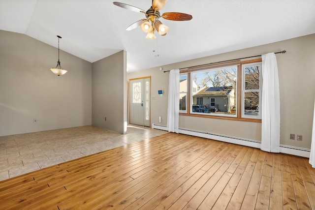 unfurnished living room with ceiling fan, a baseboard radiator, and vaulted ceiling