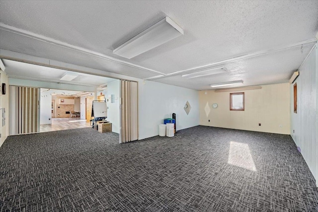 basement featuring carpet and a textured ceiling