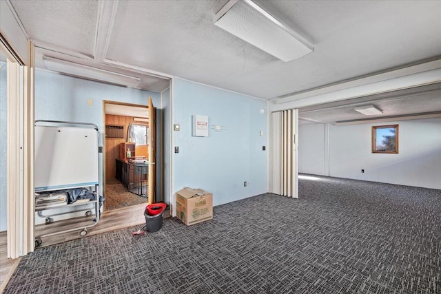 basement with carpet floors and a textured ceiling