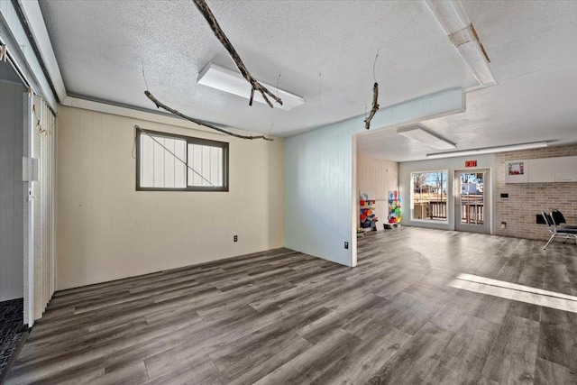 basement featuring hardwood / wood-style floors and a textured ceiling