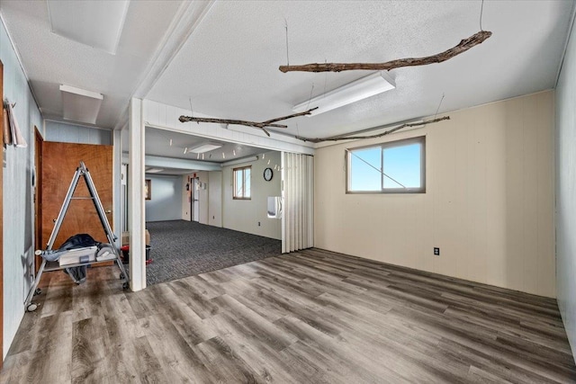 basement featuring hardwood / wood-style floors and a textured ceiling