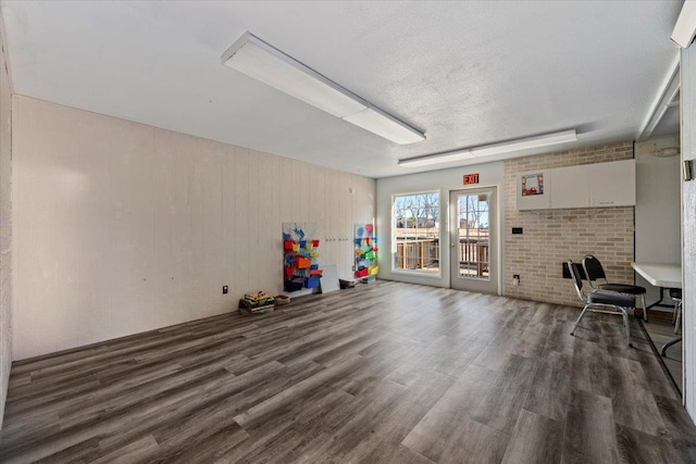 interior space featuring dark wood-type flooring and a textured ceiling