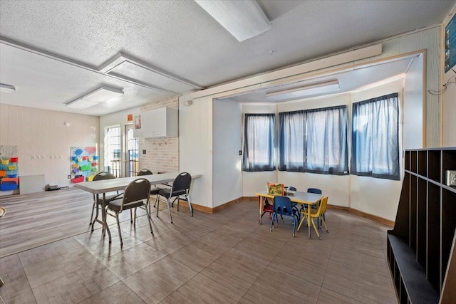 recreation room featuring a textured ceiling