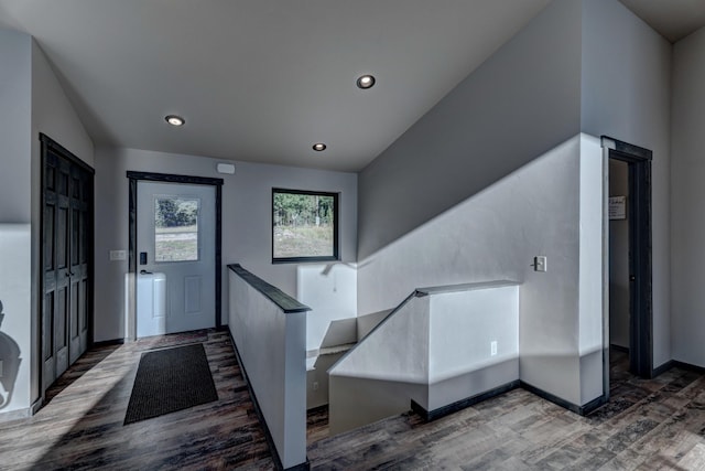 entryway featuring hardwood / wood-style floors and vaulted ceiling