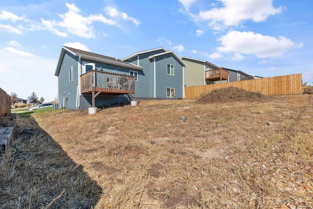 back of house with a wooden deck