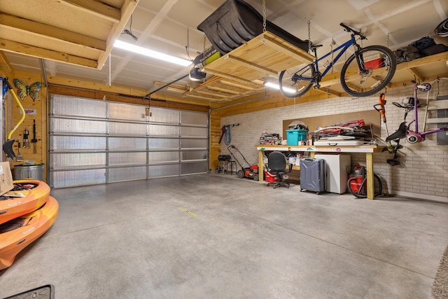 garage with a workshop area and a garage door opener