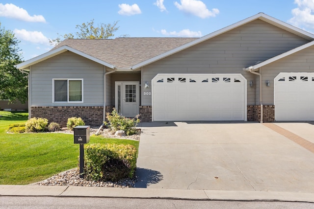 single story home with a front yard and a garage