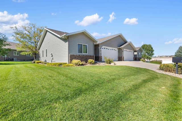 view of front of property with a garage and a front lawn