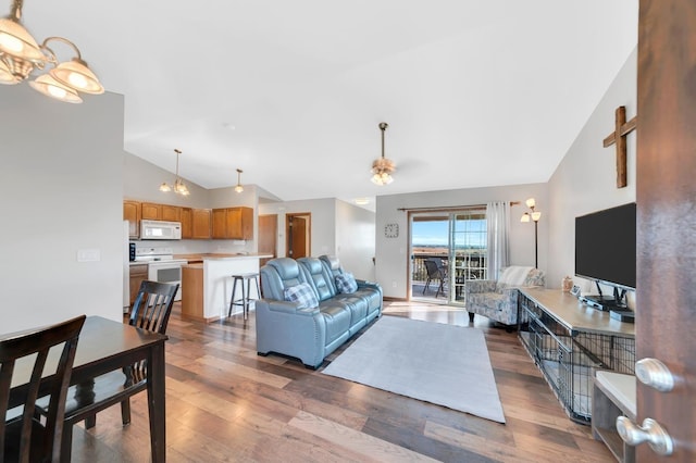 living room featuring ceiling fan, hardwood / wood-style floors, and high vaulted ceiling