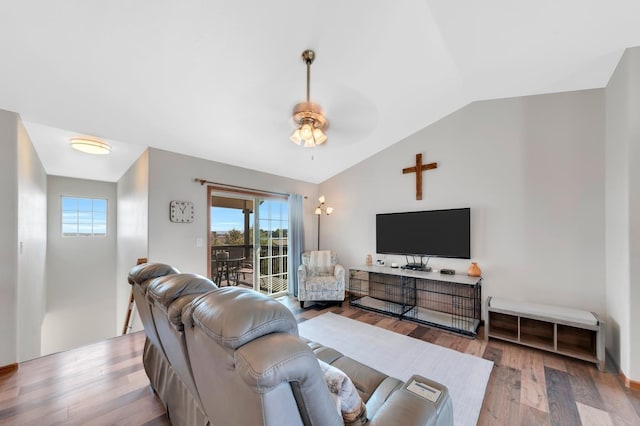 living room featuring plenty of natural light, light hardwood / wood-style floors, lofted ceiling, and ceiling fan