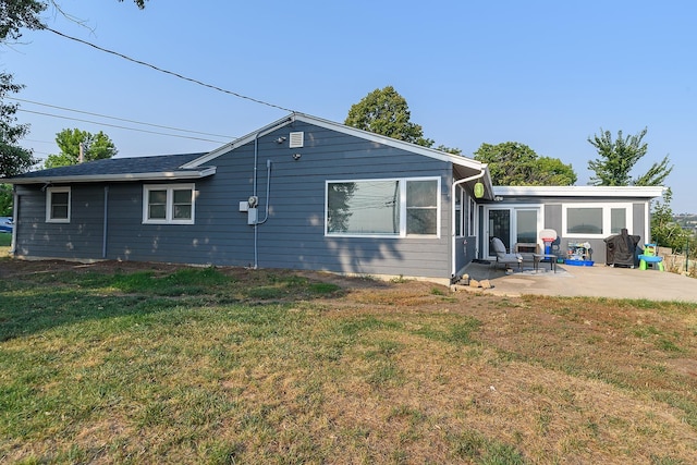 back of house featuring a patio area and a yard