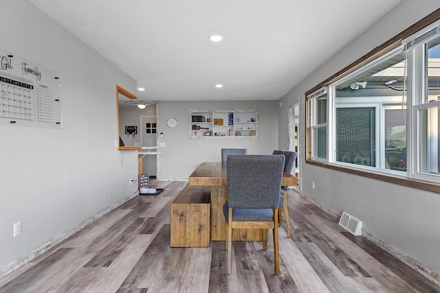 dining area with hardwood / wood-style floors